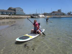Mom and daughter on paddle board