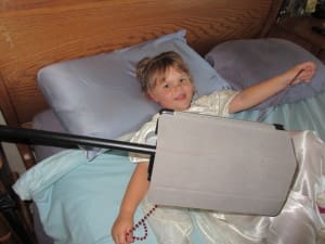 Little girl watching iPad from sky crane ipad holder