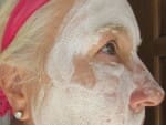 Woman using Exuviance facial products