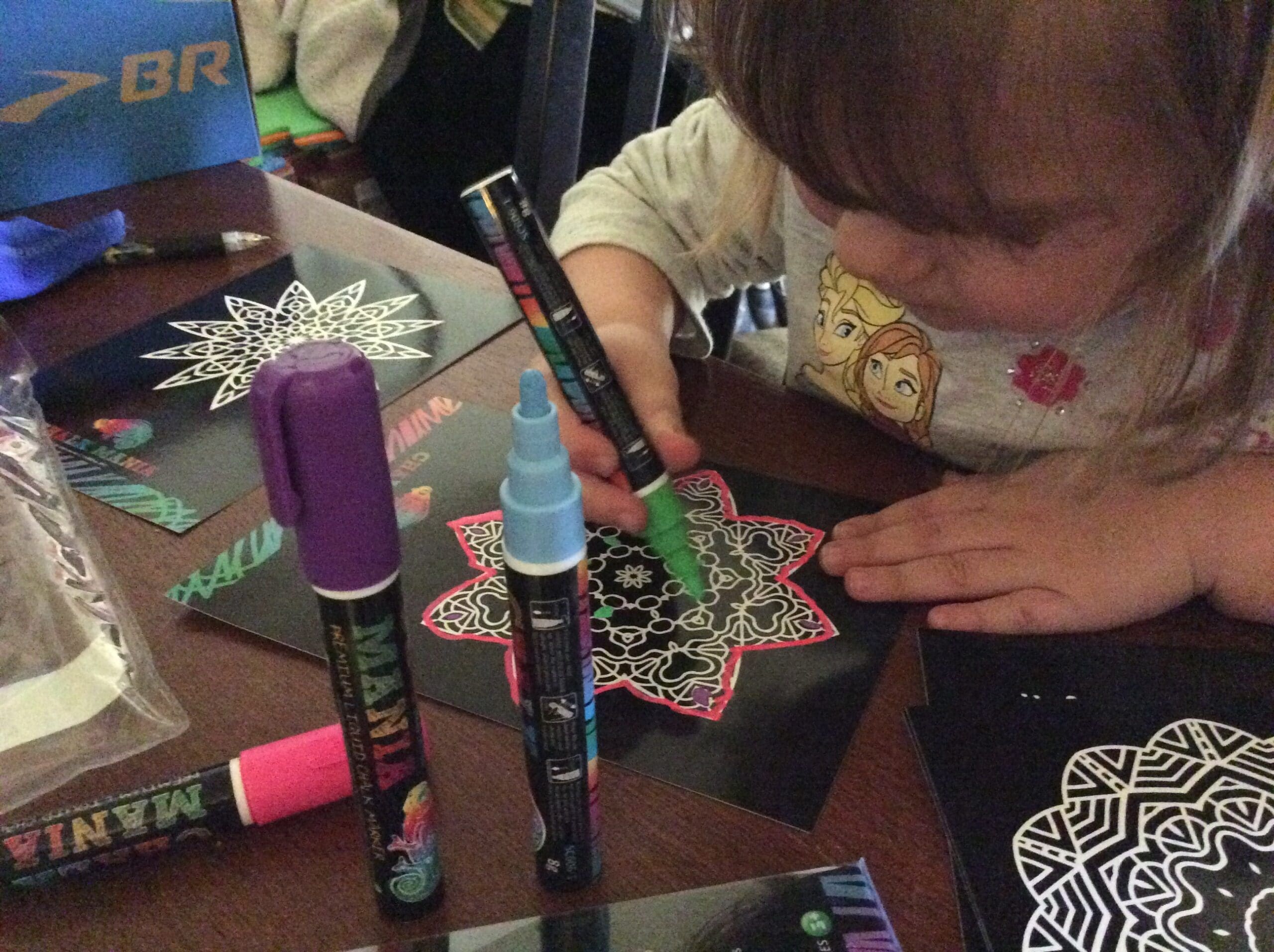 Little girl using liquid markers