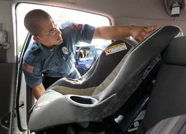 Police officer installing a car seat