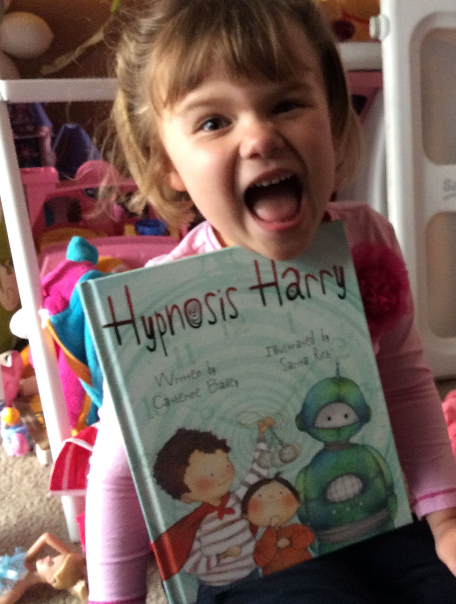 Little girl reading Hypnosis Harry Book