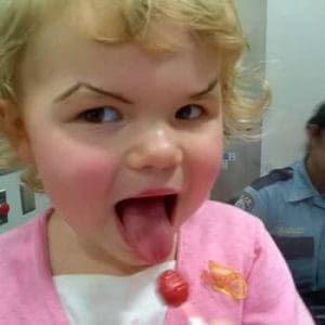Little girl with funny eyebrows painted on
