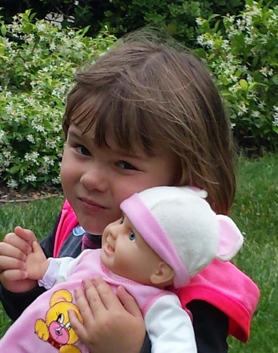 Little girl playing with her doll