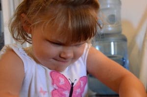 little girl playing with floof sands alive