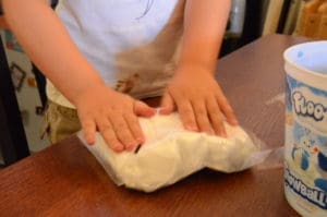 little girl playing with floof sands alive