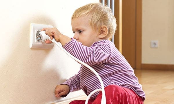 Little child with electrical outlet