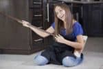 Home cleaning lady playing a broom