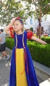 Little girl in Snow White costume at Disneyland California