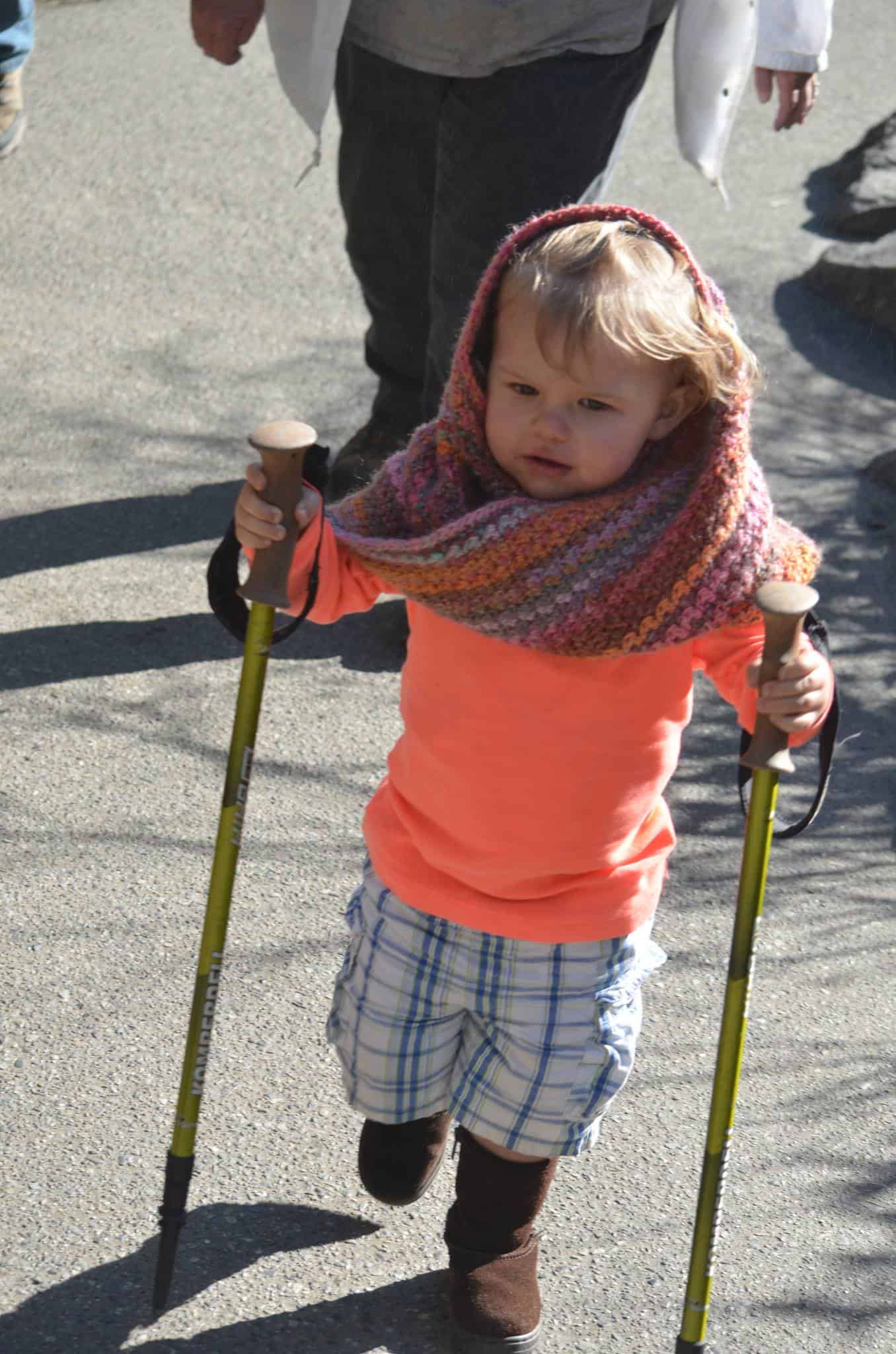 Little girl using hiking poles