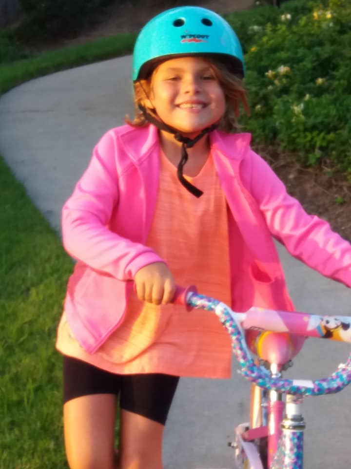 smiling girl on a bike