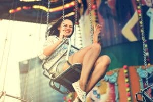 Girl on amusement park swing