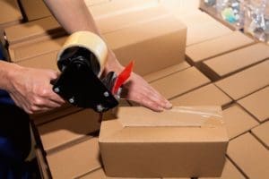 Mistakes to Avoid when Moving Man taping moving boxes