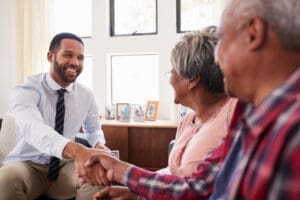 Investment Advisers Businessman shaking hands older couple