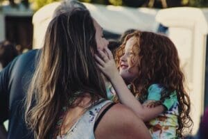 Stop Being an Absent Parent Woman carrying girl smiling