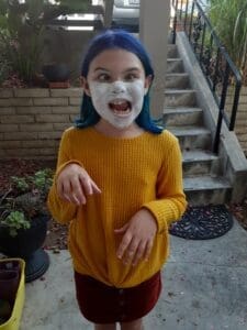 Little girl with Moms expensive face mask. Oops!