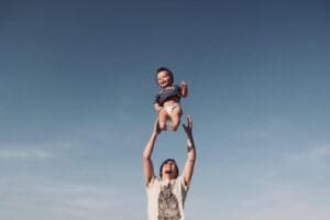 Term Life Insurance father throwing baby in the air