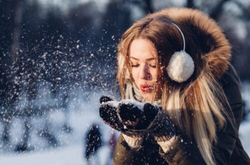 Winter skin woman blowing snow
