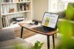 Your Company's Success working on a Laptop on coffee table 
