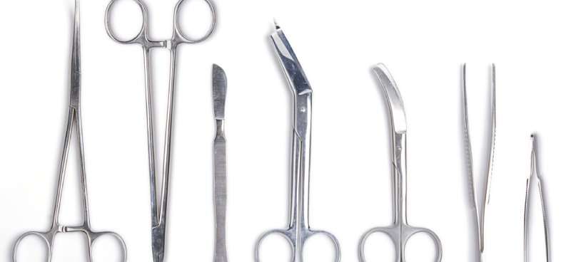 A range of different types of surgical scissors and tools used in a medical procedure.