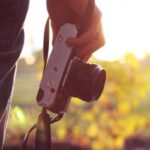 person holding a camera in a field Creative Photography