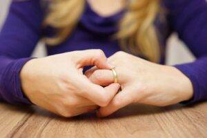 Addiction is hard on marriage, woman twisting her wedding ring