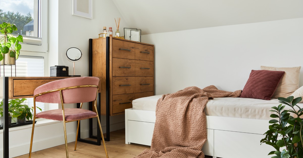 Small room with furniture featuring longer legs, more space, and a bed with storage space underneath it.