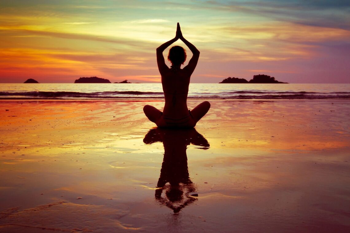 Self Care Yoga at the beach at sunset