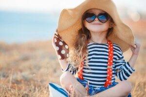 Sun burn protection little girl with hat and sunglasses