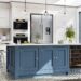 A modern kitchen with white cabinets, a blue center island, and stainless steel appliances on a sunny day.