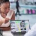 A professional woman real estate agent presents property options on her laptop to a happy man in her office.