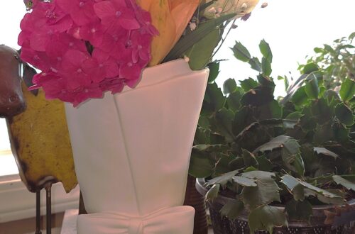 white ceramic vase with a bow