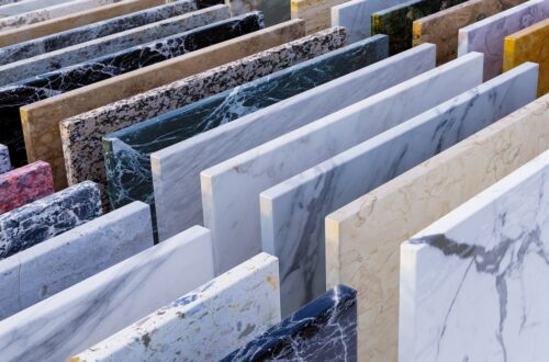 Rows of square natural stone samples in a range of colors showing different variations and patterns.