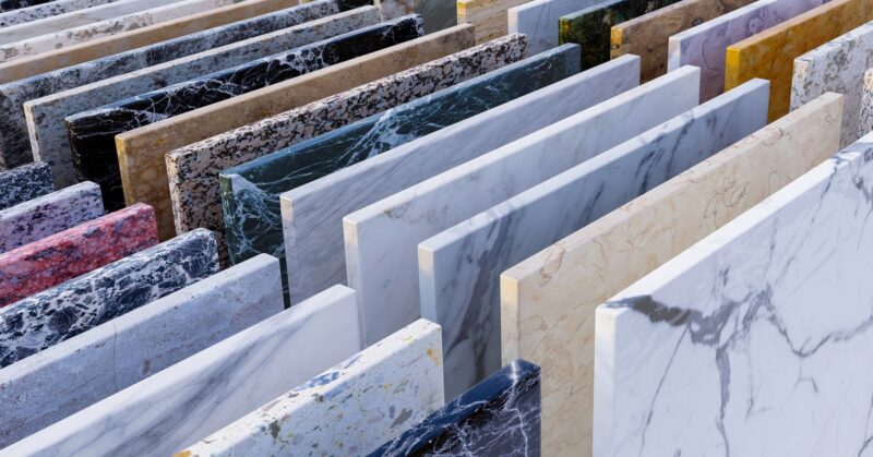 Rows of square natural stone samples in a range of colors showing different variations and patterns.