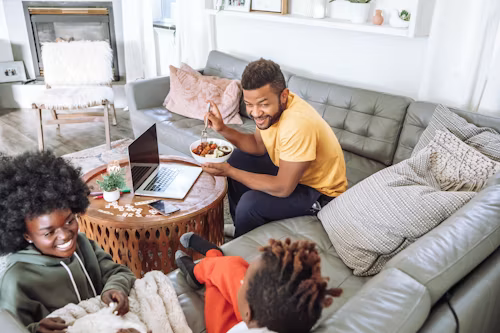 Home Upgrades a family sitting in a living room.