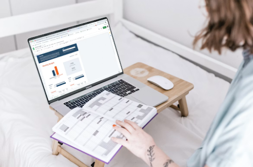woman working on a laptop, with her calendar showing. Smart Money Habits