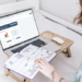woman working on a laptop, with her calendar showing. Smart Money Habits