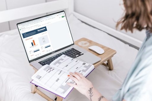 woman working on a laptop, with her calendar showing. Smart Money Habits