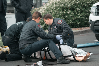 EMTs working on patient. Emergency Medical services