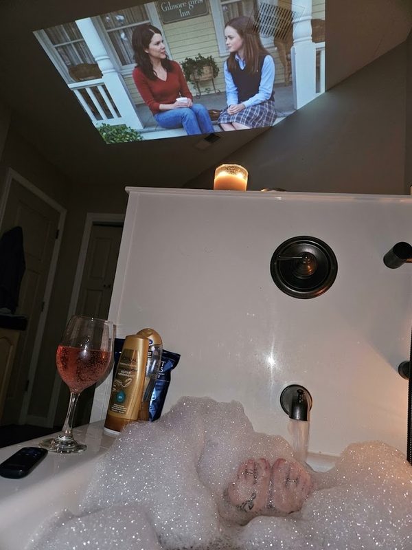 HP MC425 projector in a bathroom showing the gilmore girls on the ceiling